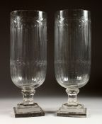 A GOOD PAIR OF ENGRAVED STORM LAMPS on square bases 15 ins high