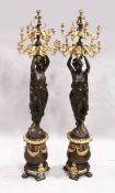 A VERY GOOD PAIR OF CLASSICAL GILDED AND BRONZE STANDING CANDELABRA standing as two classical