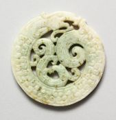 A CHINESE PIERCED JADE ROUNDEL, 2.75 ins diameter.