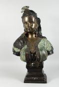 A GILDED BRONZE BUST OF AN ARAB LADY with plumed head dress and bead decoration, 2 ft. 5 in. high.