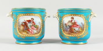 A GOOD PAIR OF SEVRES BLUE GROUND CACHE POTS 4.5 ins high with scroll handles and painted with