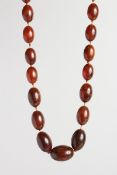 AN AMBER BEAD NECKLACE, 32 inches long