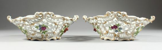 A GOOD PAIR OF 18TH CENTURY MEISSEN PIERCED OVAL BASKETS with gilt decoration and applied flowers.
