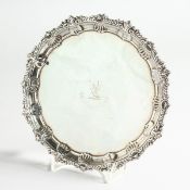 A VICTORIAN SILVER PIE CRUST SALVER, crested on three claw and ball feet London 1894, weighs 12
