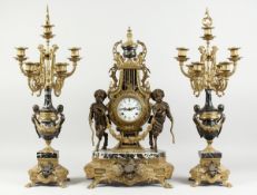 A LARGE FRENCH GILT METAL AND MARBLE THREE PIECE CLOCK GARNITURE, the clock of lyre shape wth two