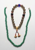 ASIAN PRAYER BEADS WITH GILT CHARM and a jade necklace, 20 inches long.