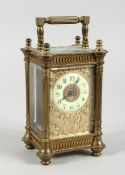 A 19TH CENTURY FRENCH BRASS CARRIAGE CLOCK with filigree face and coloured sides 61/2 ins.