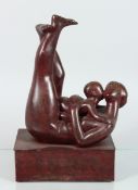 A MODERN BRONZE MOTHER AND CHILD on a rectangular base. 12 ins high.