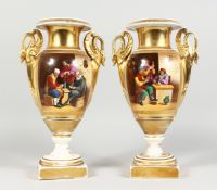 A GOOD PAIR OF EMPIRE TWO HANDLED PORCELAIN VASES with swan handles, reverse painted panels, the