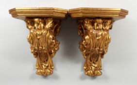 A GOOD PAIR OF GILDED WALL BRACKETS with scrolling decoration, 20 in. high.