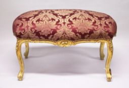 A GILT WOOD LARGE STOOL, with upholstered crimson, classical style fabric, on cabriole legs. 3 ft