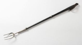A GEORGE III SILVER TOASTING FORK with turned wood handle, maker C.S. 21 ins long
