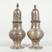 A SMALL PAIR OF SILVER PEPPER MILLS 3 inches high, Birmingham 1941.