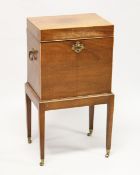 AN EDWARDIAN MAGHOGANY CELLARETTE, with rising top, compartmented interior on a stand with