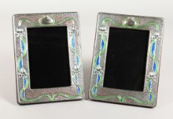 A GOOD PAIR OF SILVER AND ENAMEL PHOTOGRAPH FRAMES 7.5 ins x 5.5 ins.