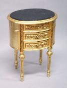 A FRENCH STYLE GILT WOOD THREE DRAWER OVAL CHEST, with black marble inset top 1 ft 8 ins wide x 1 ft