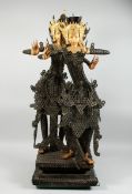 A THAI GROUP OF TWO DANCING FIGURES MODELLED FROM HUNDREDS OF COINS, 3 ft. 6 in. high