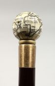A CARVED BONE GLOBE HANDLE WALKING STICK