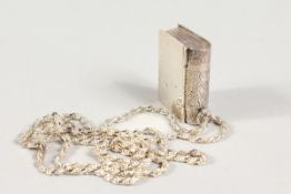 A SILVER BOOK PENDANT ON A CHAIN