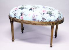A GILT WOOD LARGE STOOL, upholstered with a floral print, on square legs. 3 ft 3 ins long x 2 ft
