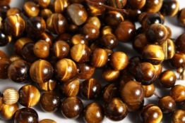 TWO TIGER'S EYE BEAD NECKLACES, 44 and 29 inches long.