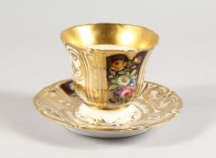 A LARGE FRENCH PORCELAIN CUP AND SAUCER edged in gilt and painted with flowers