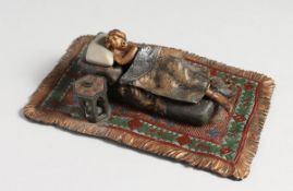 A COLD CAST NUDE on a Persian rug 6 ins long.