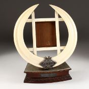 A LARGE BOARS TUSK PHOTOGRAPH FRAME, presented and made by BHOVAN BOGHA MISTRI, JETHHA MISTRI,