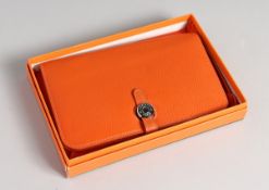 AN ORANGE LEATHER PURSE