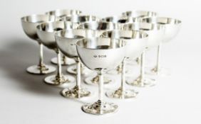 A GOOD SET OF TWELVE SILVER TOT GLASSES Birmingham 1922, weight 27 ozs.