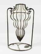 A FOUR TIER TINTED SHAPED GLASS VASE on a wrought iron stand, 13 ins diameter.