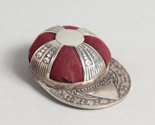 A SILVER JOCKEY CAP PIN CUSHION