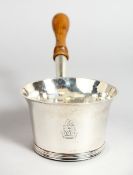 A QUEEN ANNE SILVER BRANDY POT, 3 is diameter, with turned wood handle London, 1708, maker William