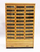 A GOOD HABERDASHERY CABINET with ten rows of three drawers with metal handles, tambour to the
