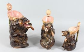A GARNITURE OF THREE PORCELAIN BEAR JUGS 13 ins, 11 ins, 8 ins high.