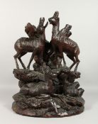 A GOOD BLACK FOREST CARVED WOOD GROUP, A FAMILY OF DEER. 18ins high.
