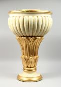 A COMPOSITION CREAM AND GILDED JARDINIERE on a circular base, 2 ft. high.