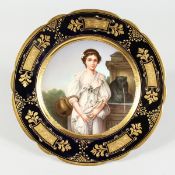 A GOOD VIENNA CIRCULAR COMPORT, blue and gilt border the centre painted with a portrait 'La Cruche