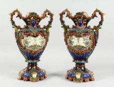 A GOOD PAIR OF CONTINENTAL POTTERY MAJOLICA DESIGN TWO HANDLED VASES, blue ground, green banding
