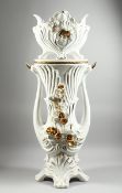 A LARGE POTTERY WHITE GILDED JARDINIERE AND STAND with gilt flowers, 3 ft 8 ins high.