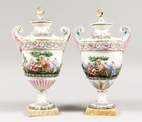 A GOOD PAIR OF CAPODIMONTE URN SHAPED, TWO HANDLED VASES AND COVERS with classical figures in relief