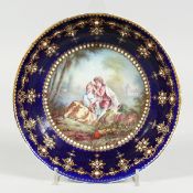 AN 18TH CENTURY SEVRES PORCELAIN CIRCULAR DEEP DISH rich blue ground, pearl work, the centre painted