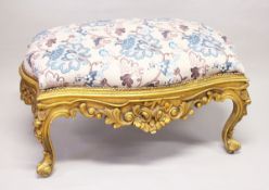 A GILT WOOD LARGE STOOL, upholstered with a floral print fabric on cabriole legs 3 ft 10 ins long