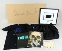 A COLLECTION OF DAMIEN HURST ITEMS: signature on a large piece of cardboard, workshop tops, overalls