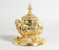 A GOOD VICTORIAN SILVER GILT CIRCULAR POT AND COVER with masks on claw feet with circular base, 5.25