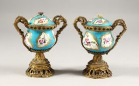 A GOOD PAIR OF 19TH CENTURY SEVRES PORCELAIN AND ORMOLU TWO-HANDLED VASES AND COVERS, blue ground
