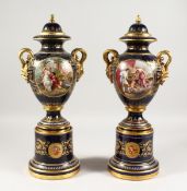 A SUPERB PAIR OF VIENNA VASES, COVERS AND STANDS, the rich blue ground edged in gilt and painted