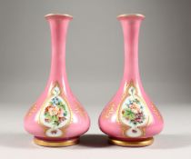 A GOOD SMALL PAIR OF 19TH CENTURY BOHEMIAN PINK GLASS VASES, each painted with three panels of