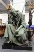 ITALIAN CIRCA. 1875 A MASSIVE COPPER SCULPTURE OF SAINT FRANCIS OF ASSISI seated resting his head on