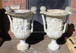 A SUPERB NEAR PAIR OF ITALIAN CARVED WHITE MARBLE TWO HANDLED URNS. the sides carved with cupids